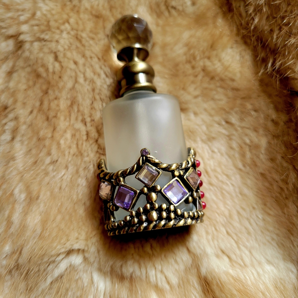 Crown Design Perfume Bottle with Gold and Purple Accents